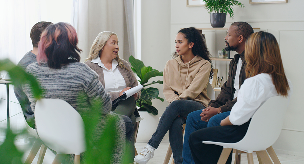 group of people attending a mental health session and discussing together